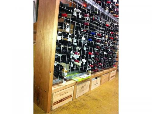 Galvanised wine racks in joinery with storage below